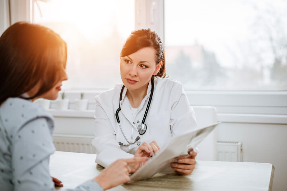 Beautiful Female Doctor Explaining Results to Her Patient.