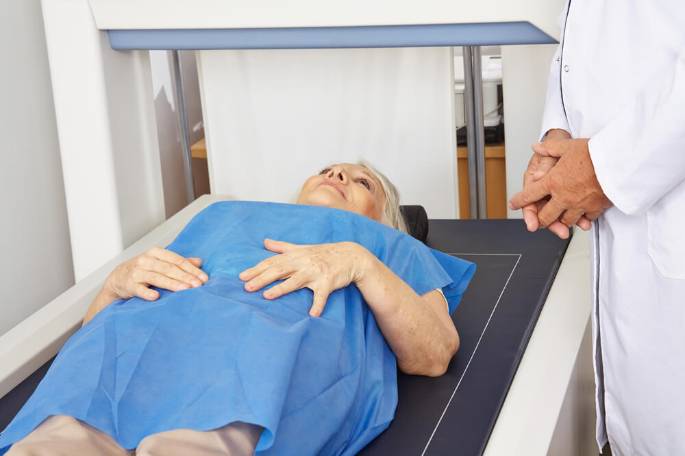 Senior Woman Under DPX Machine for Bone Density Measurement in a Hospital