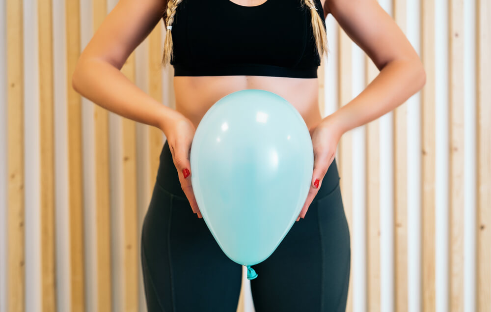 Close Up of a Young Woman Holding a Balloon to Explain the Diaphragm Zones, Core and Pelvic Floor