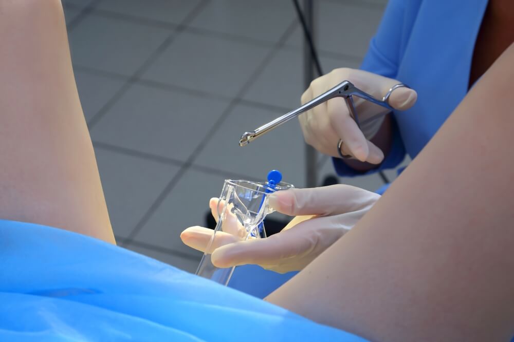 A Gynecologist Performs A Cervical Biopsy Gynecological Chair A Woman At The Gynecologist For A Check-up