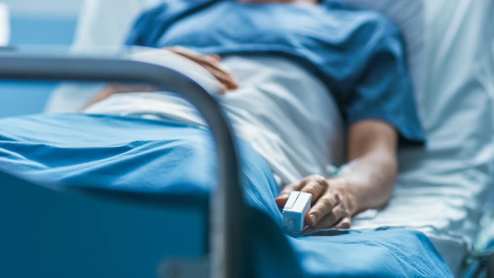 In the Hospital Sick Male Patient Sleeps on the Bed.