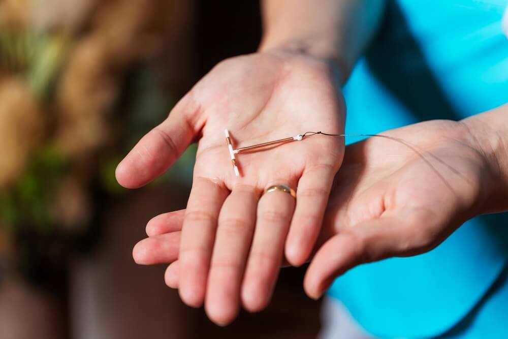 Female Contraceptive Spiral in the Hands of a Woman