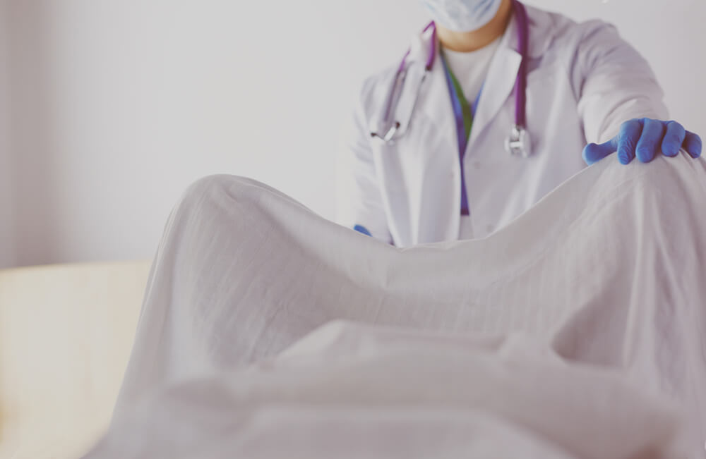 Male Obstetrician and Scrubs Nurse Are Delivered to the Pregnant Woman in the Delivery Room of the Hospital