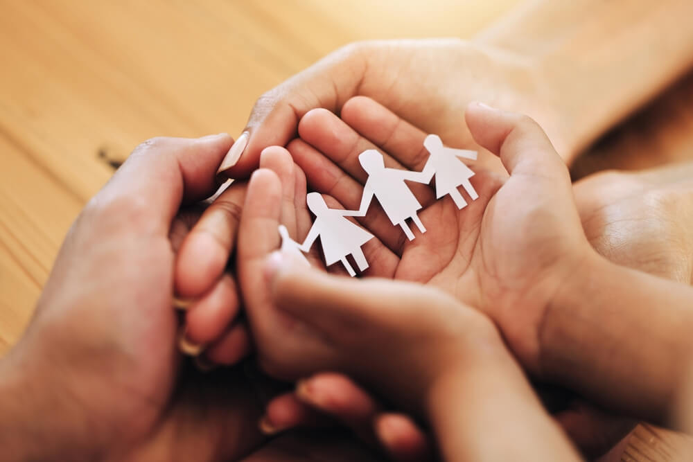 Hands, family and paper cutout, support and connection, link and bonding, foster care and adoption.
