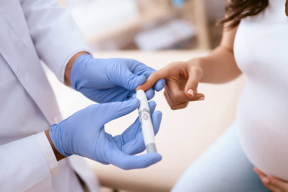 The Doctor Makes a Blood Test for a Pregnant Girl. She Came to the Clinic.