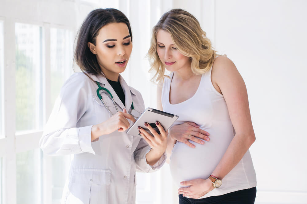 Doctor Sharing Her Notes With Pregnant Patient