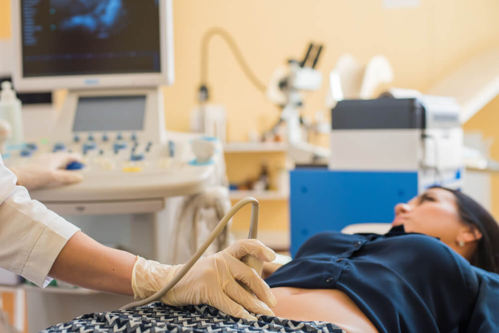 Happy Pregnant Female Visiting Women's Doctor In The Maternity Center, Doing Ultrasound Scan, Worried About The Health Of The Child, Healthy Motherhood Concept