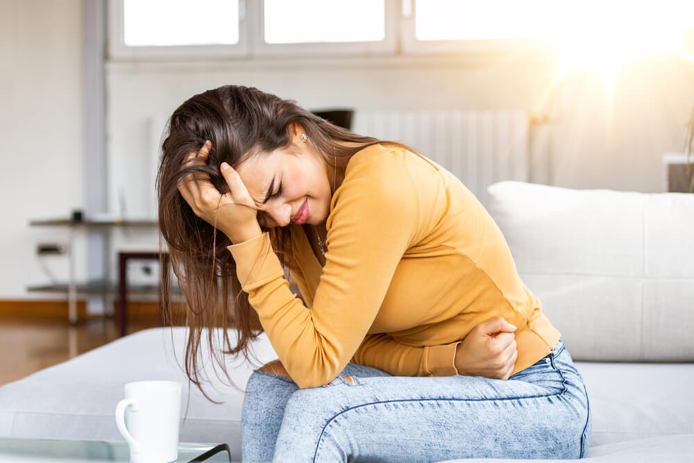 Young Sick Woman With Hands Holding Pressing Her Crotch Lower Abdomen. Medical Or Gynecological Problems