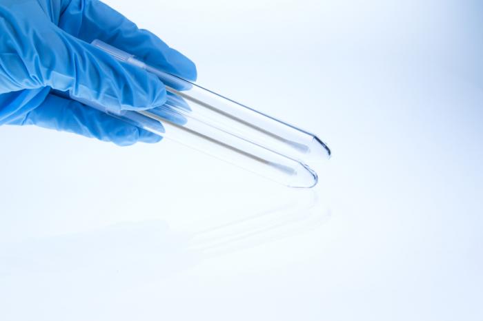 Hand in Blue Glove Holding a Couple of Test Tubes