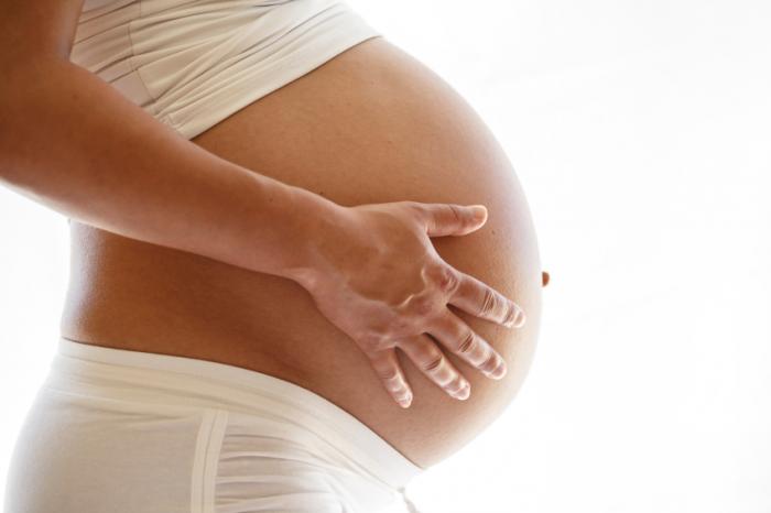 Pregnant Woman With Her Hands on Her Belly