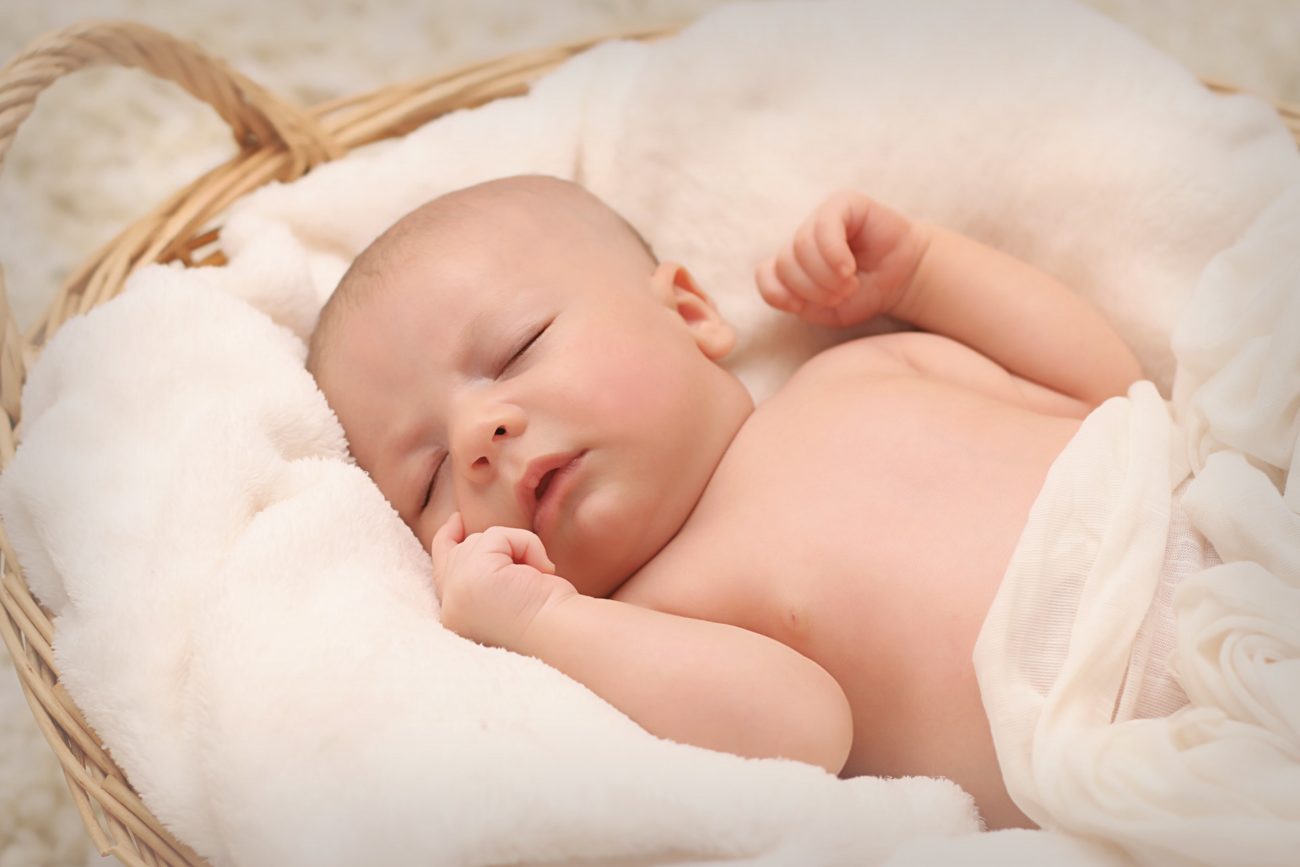 Sleeping Baby in a Wooden Basket