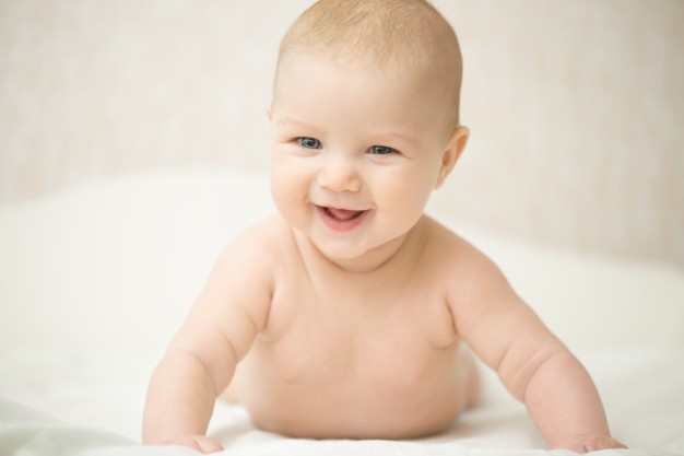 Close-up of a Smiling Baby on the Bed