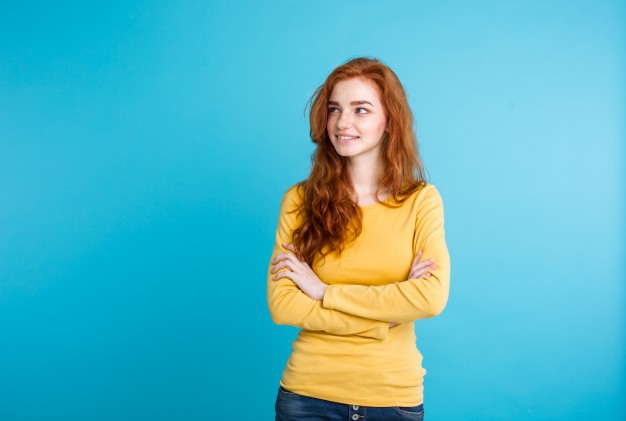 Red Haired Girl in Yellow Shirt on the Blue Background