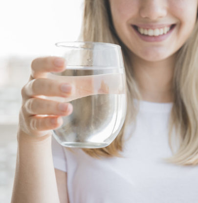 Smiling Woman Holding a Glass of Water