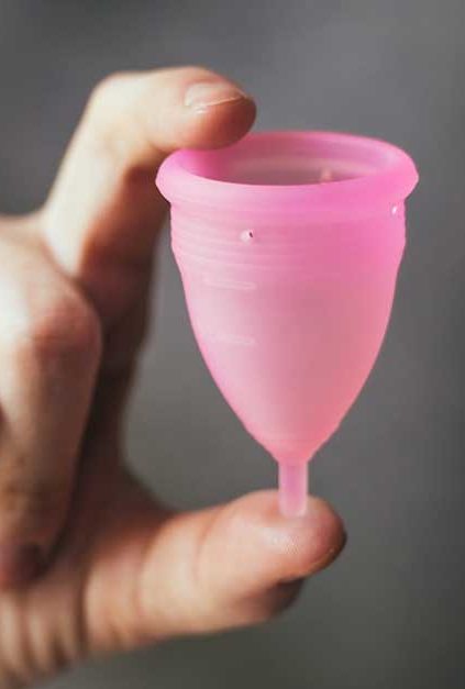 Fingers Holding a Menstrual Cup