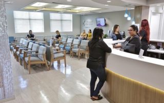 Several Women Talking at the Reception Desk at the Waiting Room