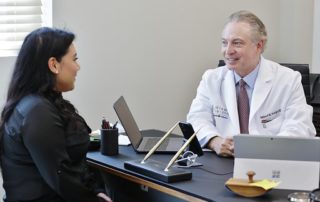 Patient In Black Sitting at the Doctors Table