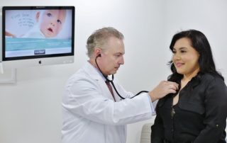 Grey Haired Doctor Examining Woman in Black Shirt