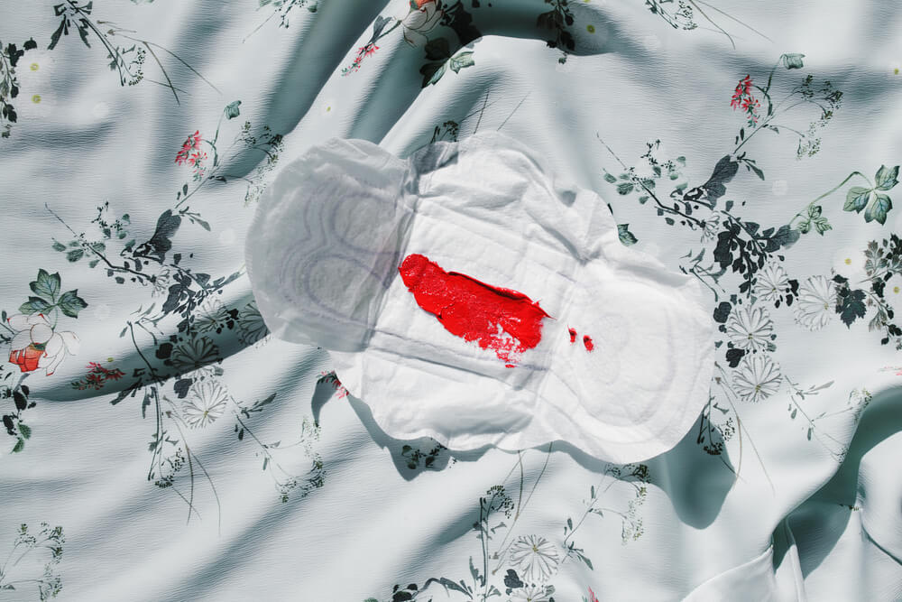 Sanitary Pad With Menstrual Blood on Print Pattern. Top View.