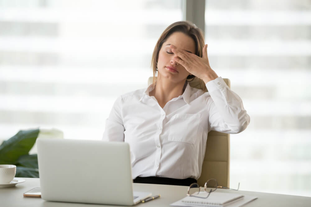 Female Office Worker Feels Dizzy From Headache 