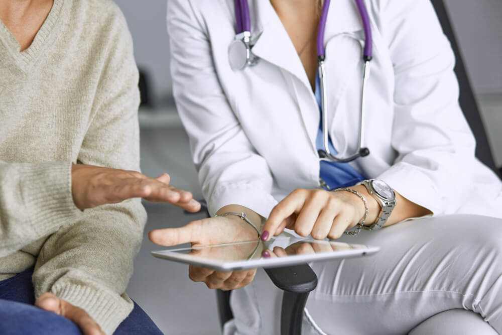 Female Doctor Talking to a Patient on a Tablet