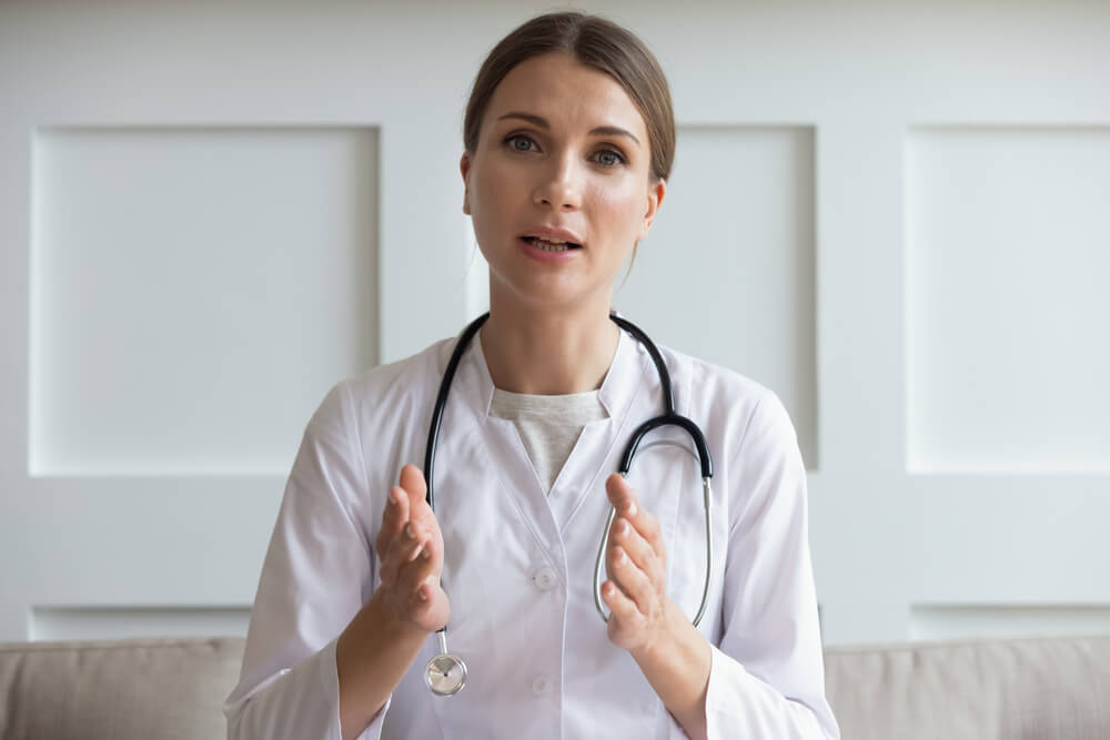 Head Shot Portrait Woman Doctor Talking Online With Patient