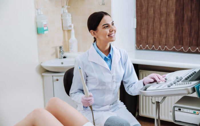 Female Doctor Conducting Ultrasound Examination of Woman in Clinic