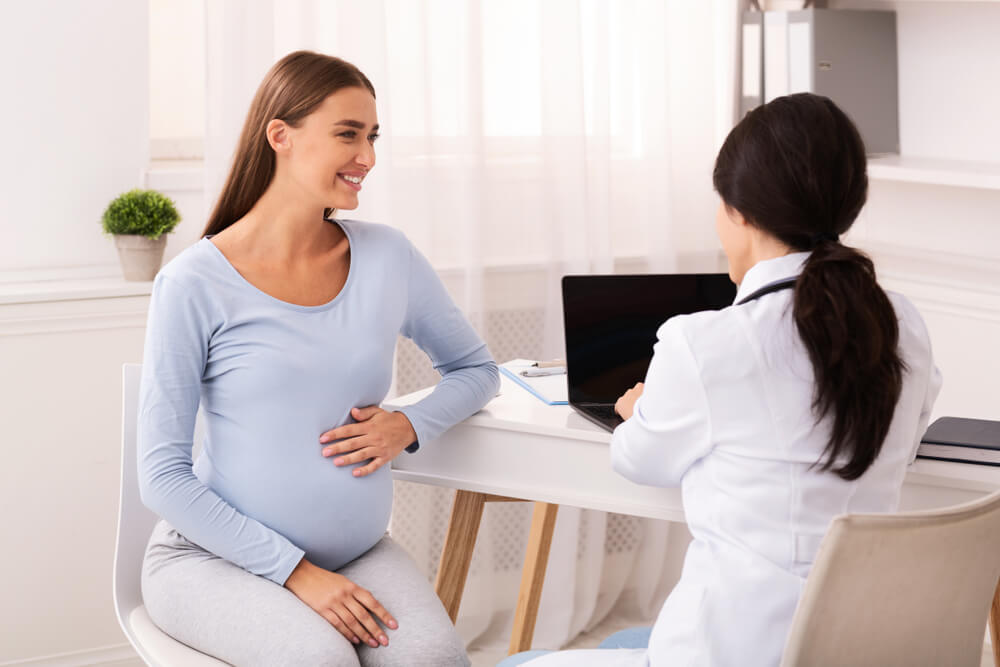 Smiling Pregnant Woman Patient Talking With Doctor