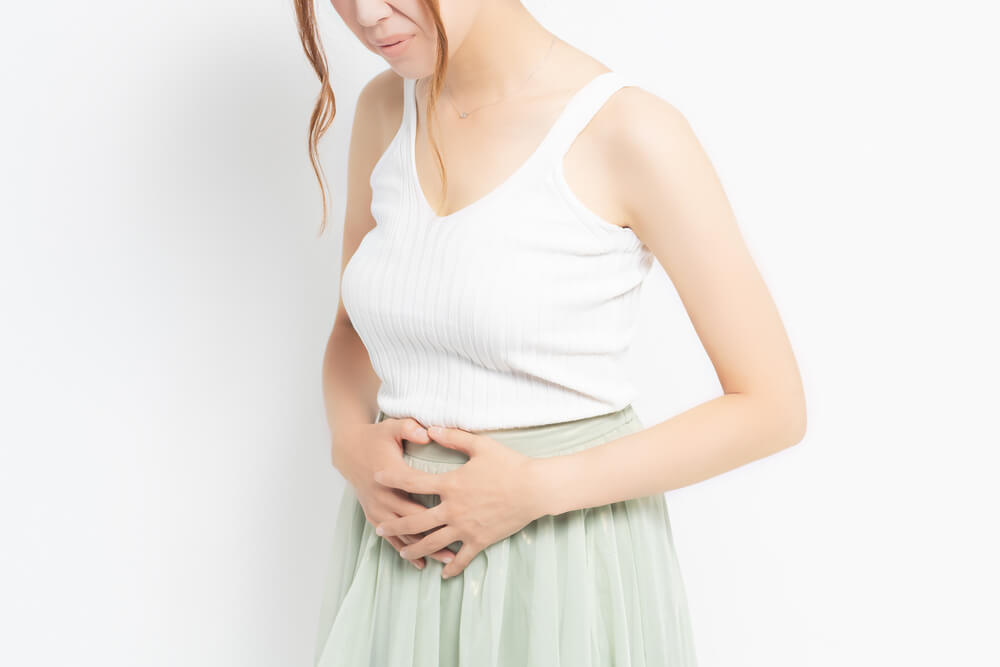 Young Woman Putting Her Hand on Her Stomach