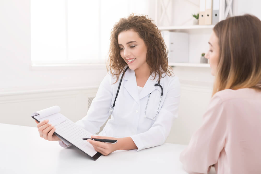 Harming Female Doctor Giving Advice To Female Patient