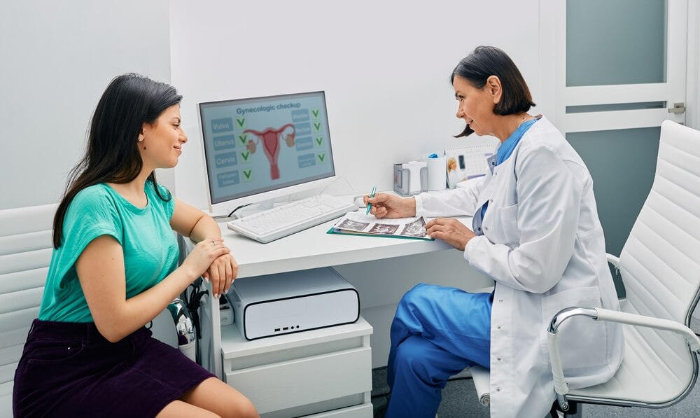 Doctor and Woman Patient Is Talking in Gynecological Office During Visit at Gynecology Office