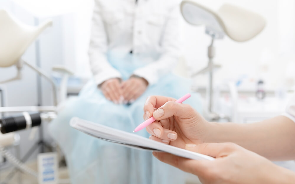 Young Woman Patient at Gynecologist Appointment Consults in Medical Institution.