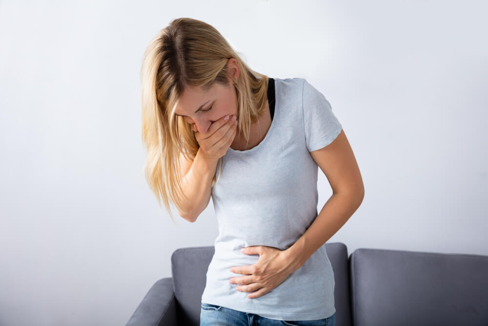 Young Pregnant Woman Feeling Pain in Her Stomach at Home