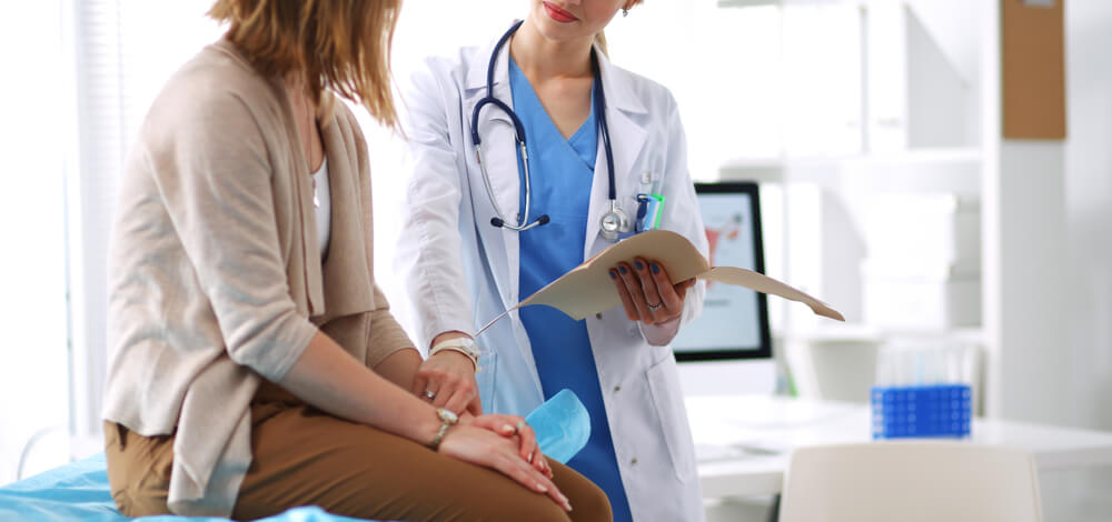 Doctor And Patient Discussing Something While Sitting