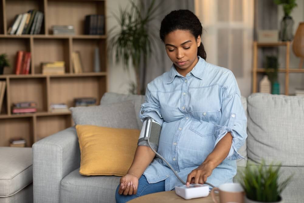 Pregnant African American Lady Measuring Arterial Blood Pressure Having Hypertension Problem