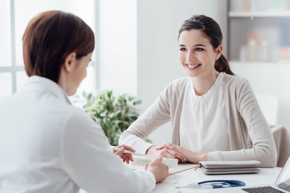 Smiling Patient In The Doctors Office She Is Receiving A Prescription Medicine