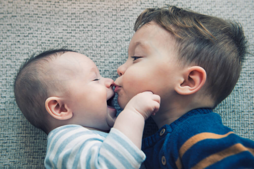 Baby Boy Kisses His Happy Brother
