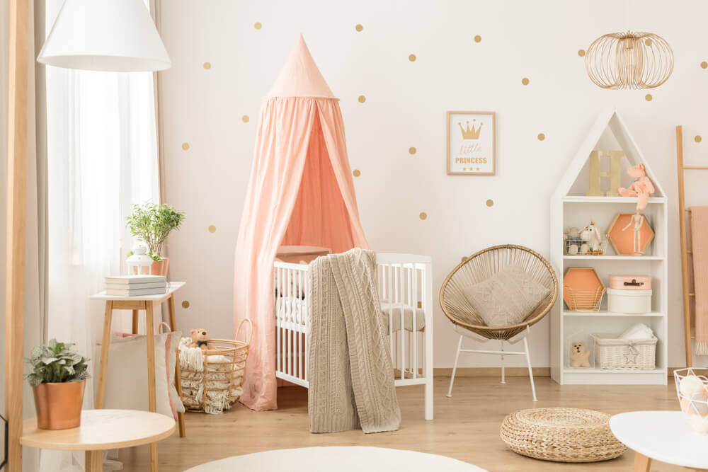 White Bookcase With Plush Toys and Decorations in a Cute Cozy White and Peach Pink Scandinavian Nursery Interior