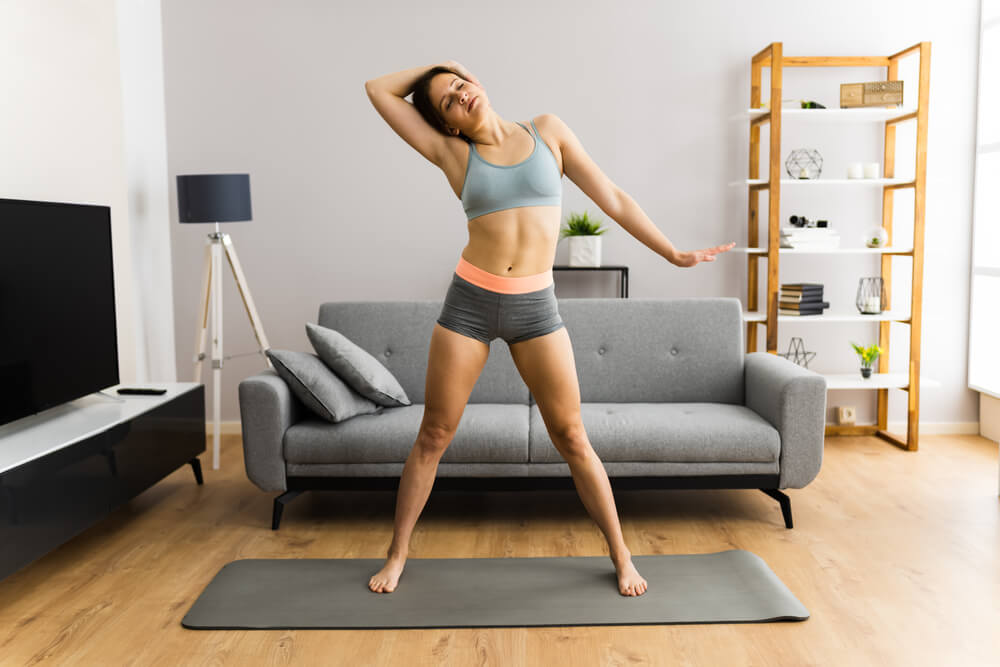 Young Woman In Fitness Wear Doing Exercise At Home