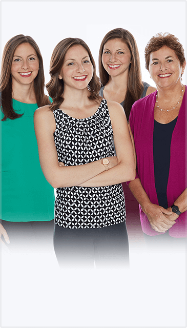 Four Women Standing Next to Each Other