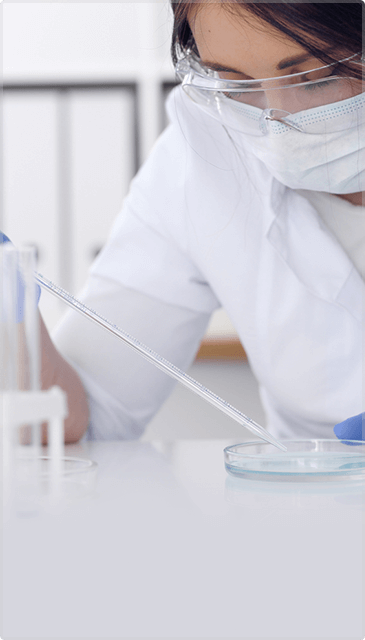 Female Doctor Wearing Protective Glasses Doing Lab Research