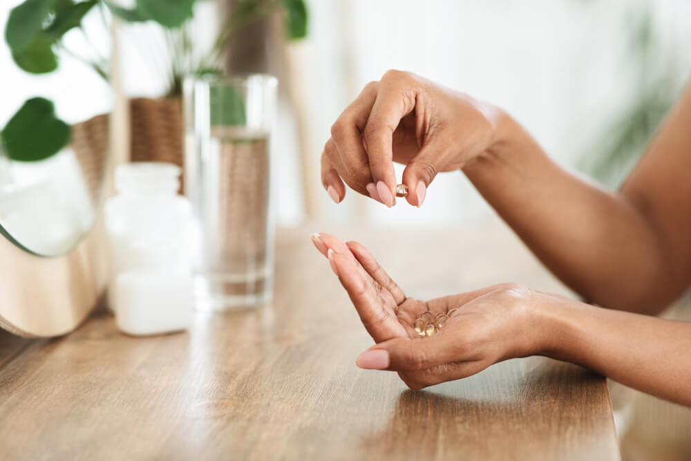 Woman Holding Supplements in Her Hand