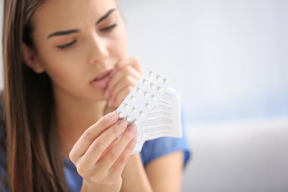 Young Woman With Pills at Home, Closeup.