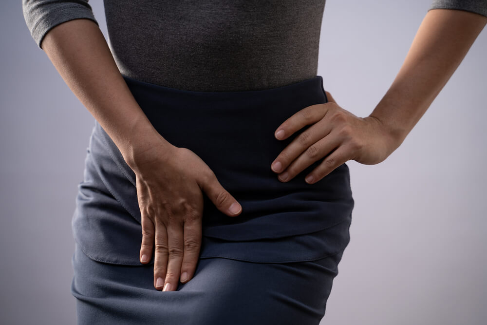 Closeup Shot of Woman Having Painful Holding Hands Pressing Her Crotch Lower Abdomen Isolated on Background
