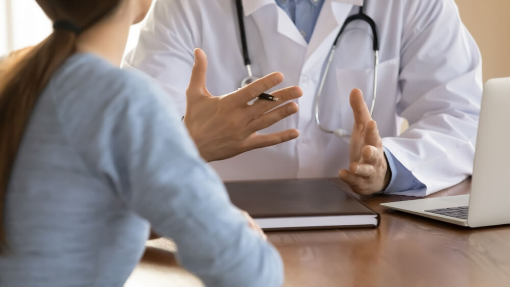 Close up Doctor Therapist Consulting Female Patient at Meeting