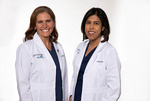 Couple of Female Doctors Smiling at the Camera