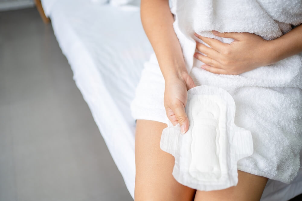 Woman Hands Holding Sanitary Napkins or Menstruation Pad Before Wearing It