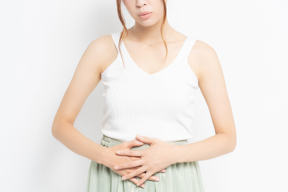 Young Woman Putting Her Hand on Her Stomach