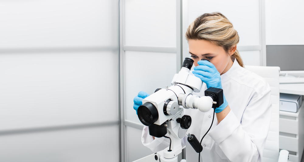 Gynecologist Woman Sitting Near a Colposcope in Her Gynecological Office