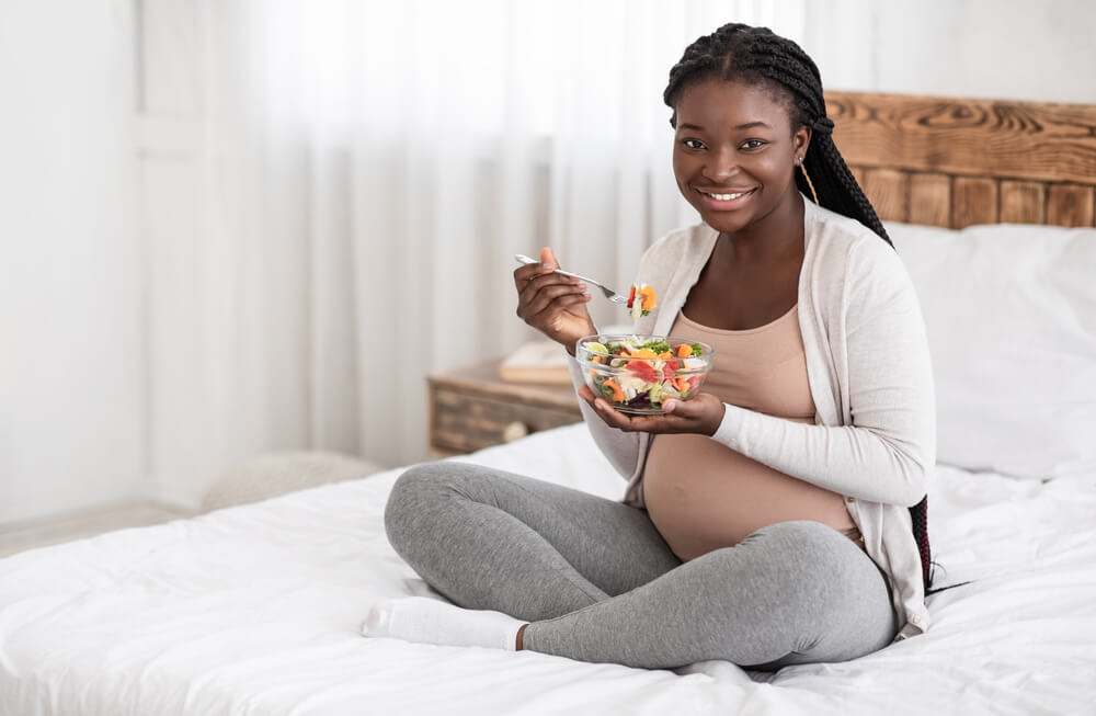 Pregnant Woman Eating in Bed